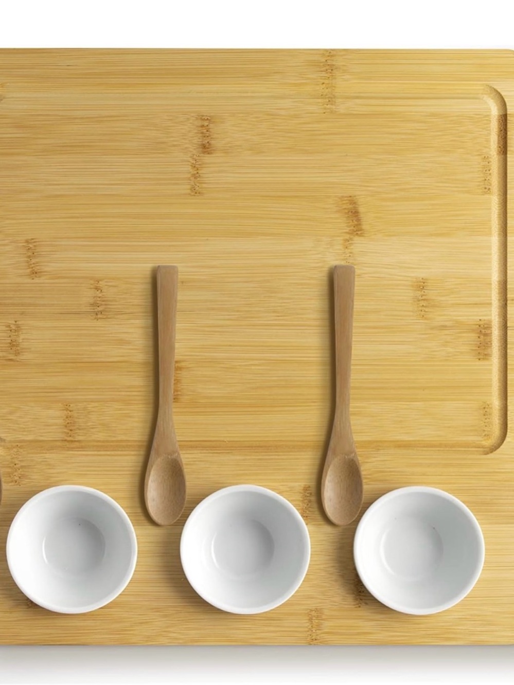 Bamboo Serving Board with Three White Ceramic Bowls and Wooden Spoons
